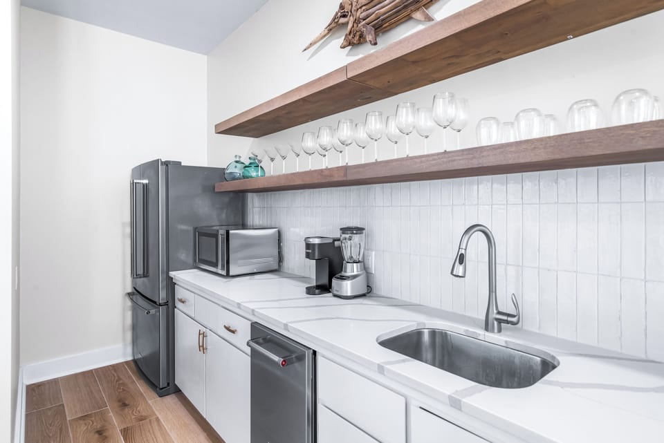 Full Size Living Room Bar with a Second Full Size Refrigerator and Free Standing Ice Maker and Wine Cooler, Microwave, Keurig and Blender!! With Seating for 4 More!!