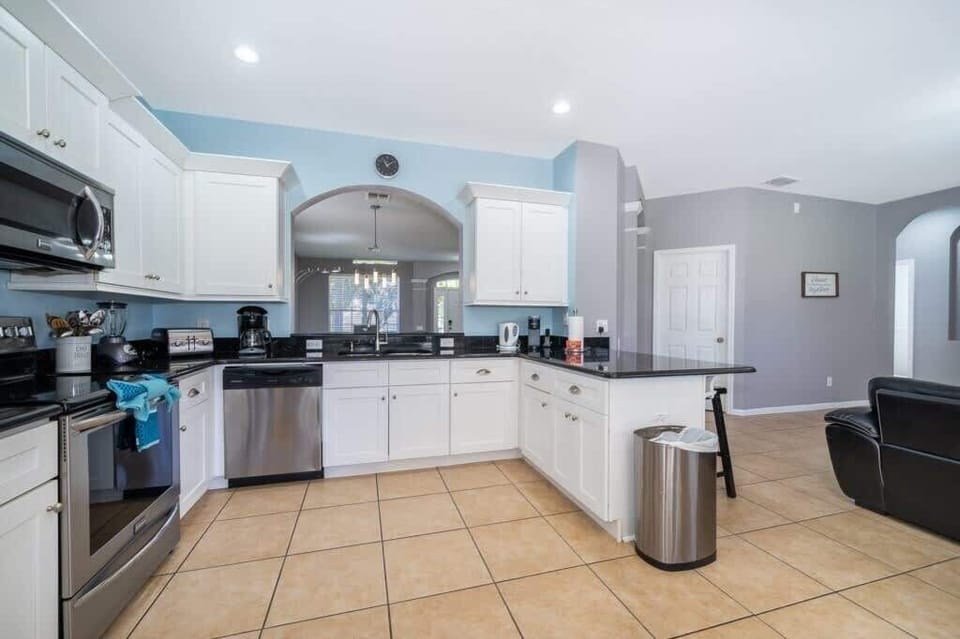 Open kitchen offers a bright, airy feel with a contemporary design that flows effortlessly into the living and dining areas. 