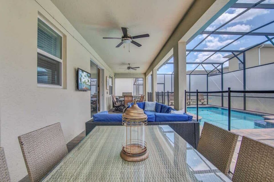 Pool area with great couch, tv, BBQ, table and loungers!