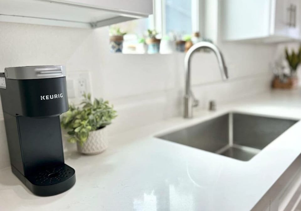 Keurig coffee maker provided, along with tea, sugar, salt and pepper