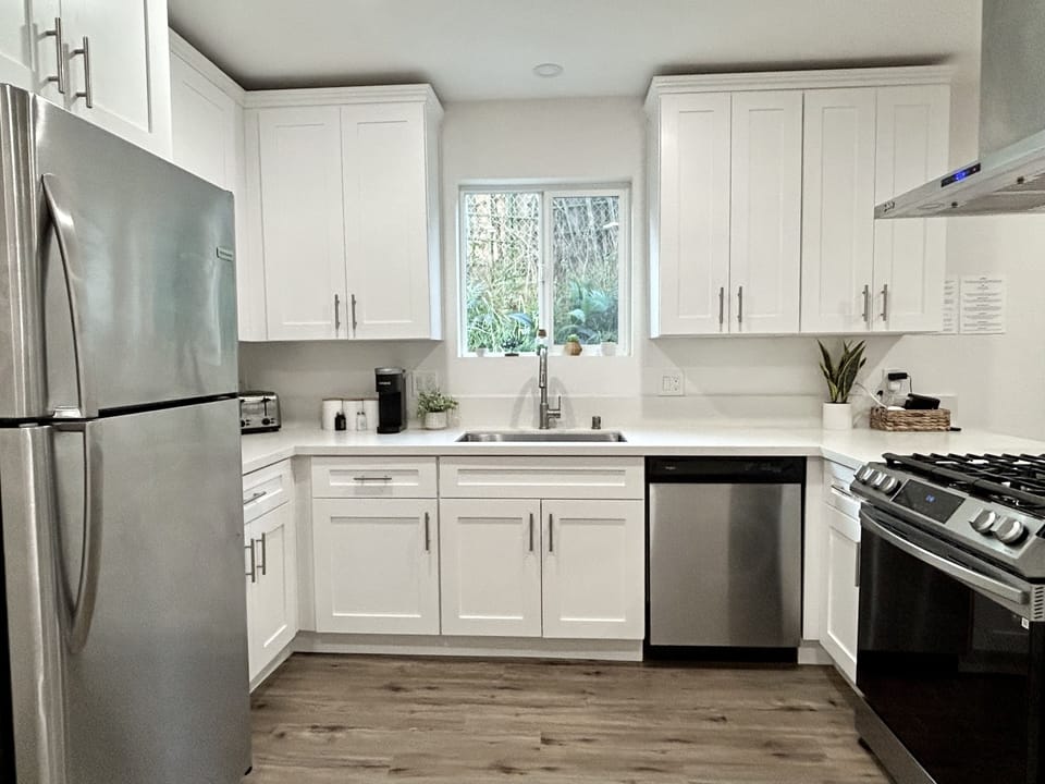 Newly renovated kitchen with gas range, microwave, toaster, dishwasher