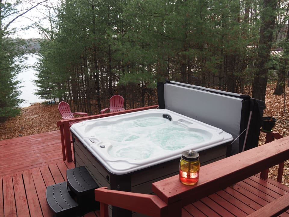 OVERVIEW:  The wonderful new year-round hot tub / spa with the private lakefront in the background.