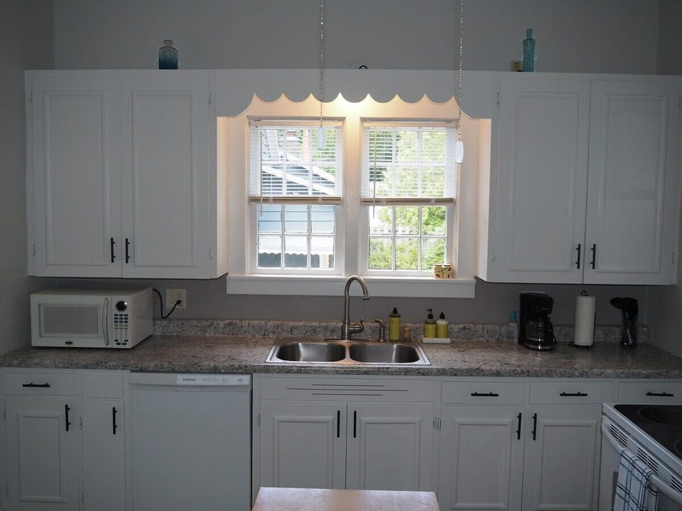 KITCHEN:  The home has a HUGE kitchen that is complete with all modern appliances, including a dishwasher.  A good supply of cooking and dining utensils are included as well.
