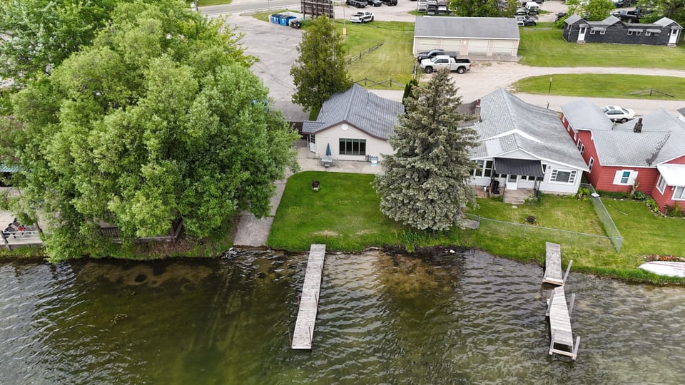 OVERALL:  A drone shot of the house with the dock in view