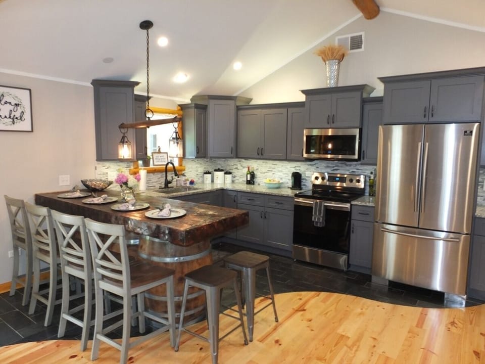 KITCHEN:  An overview of the kitchen, which includes all stainless steel appliances, including a beautiful French door refrigerator, electric range, microwave, sink, dishwasher, countertop, and lots of cabinets!