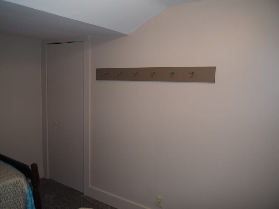 BEDROOM #2:  Features 2 twin beds, window A/C unit, nightstand, lamp, and mirror.