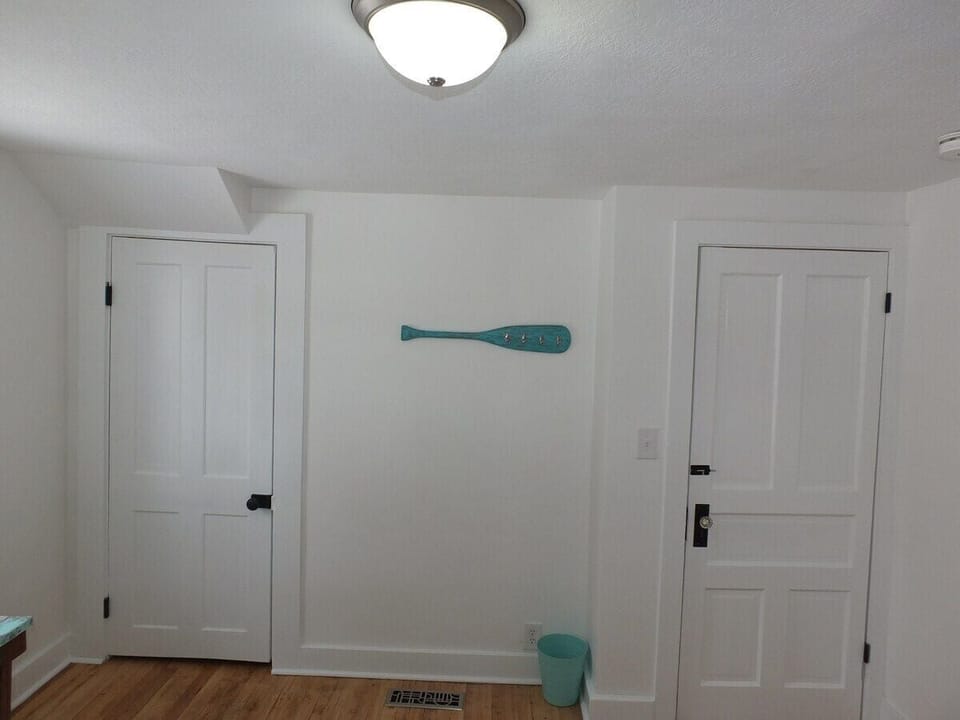 Bedroom #1 (downstairs):  The closet door is on the left and the door to the bedroom is on the right.