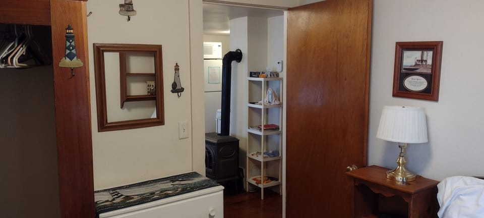 BEDROOM #1:  Features a full-size bed, nightstand, lamp, dresser. and closet.