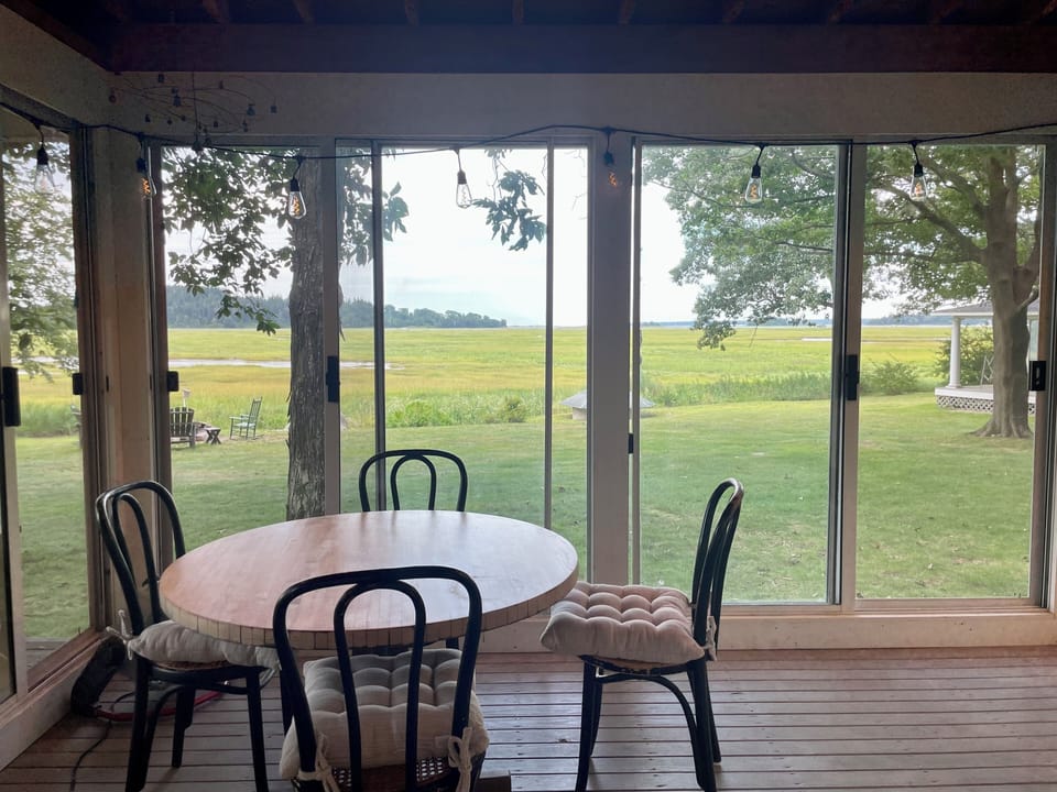 Dining area overlooking the fire pit and marsh