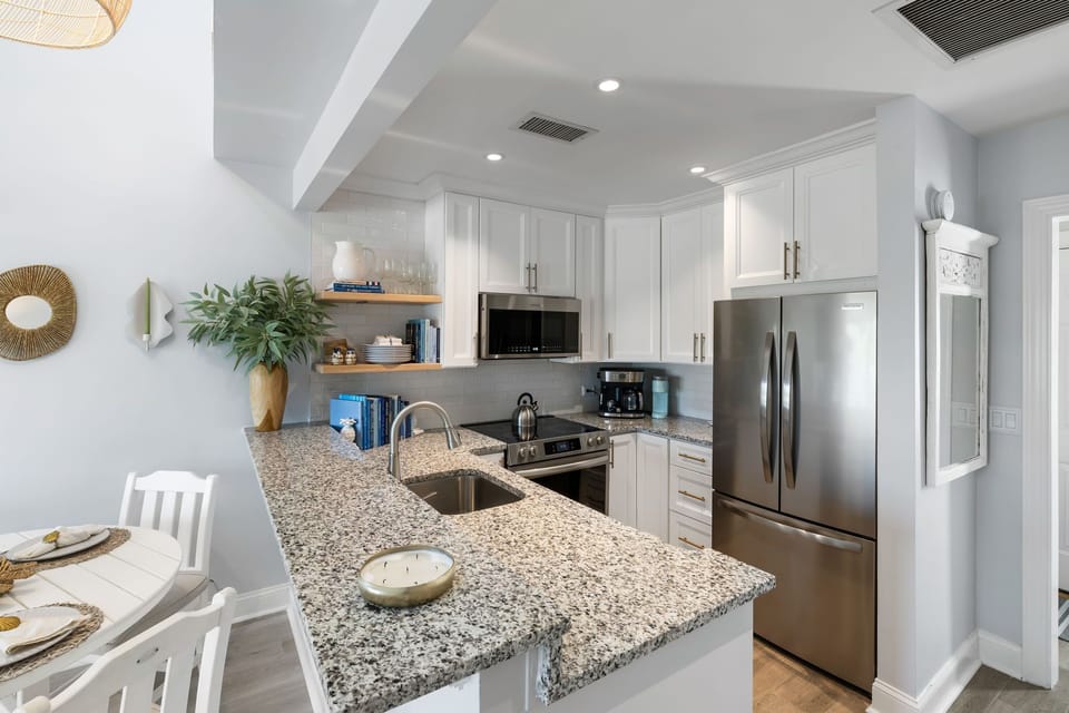 Airy chef’s kitchen w/ island seating for easy gatherings.