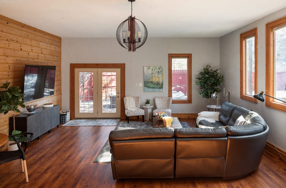 Kick back and unwind in the spacious living room, complete with a luxurious leather recliner sectional and a 75" Smart TV. An additional dining table provides the perfect spot for card games, puzzles, or a fun family game night.