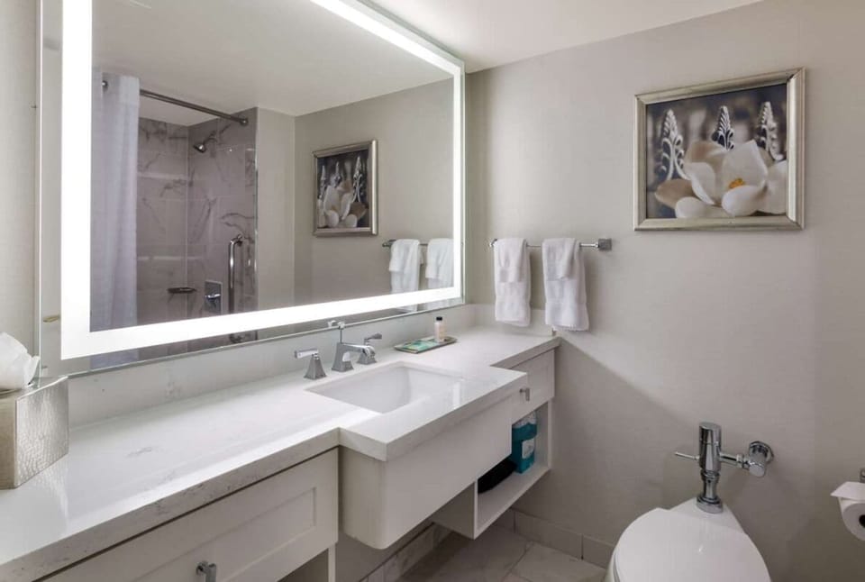 Refresh in a spotless bath with a glowing vanity mirror.