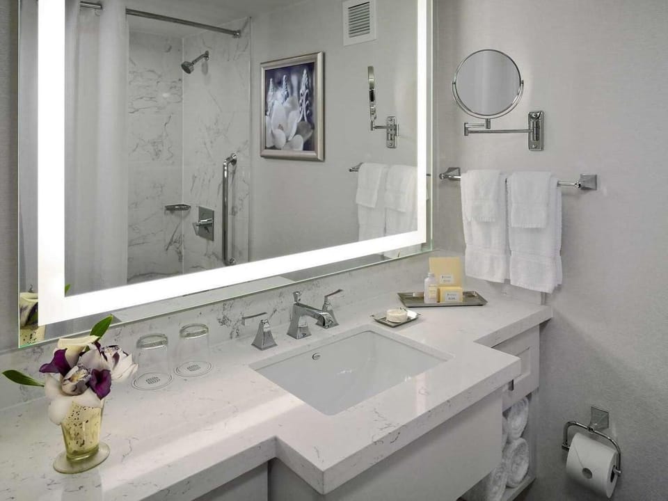 Refresh in a spotless bathroom with bright, modern finishes.