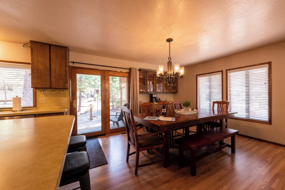 Large dining room table seats 8 plus 3 stools at the counter.