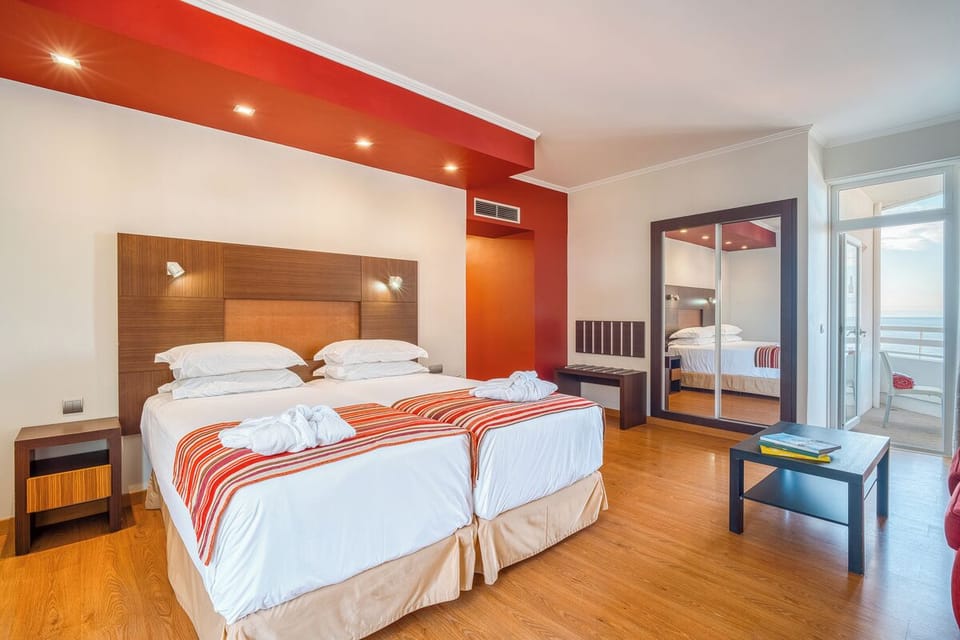 Unwind in crisp twin beds with breezy balcony views.