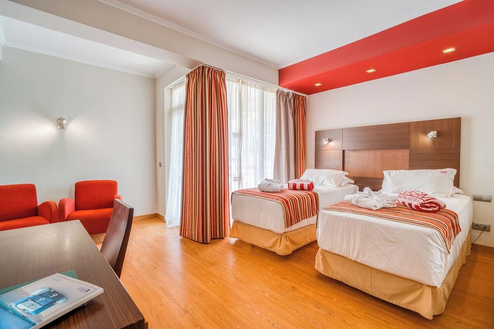 Settle into twin beds with fresh towels and calm lighting.