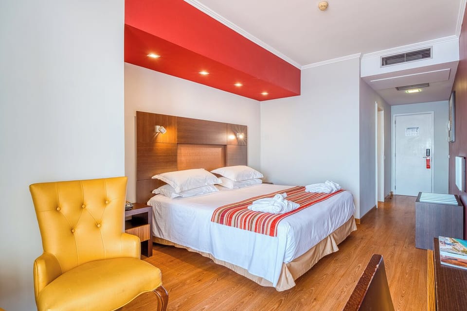 Unwind in a cozy room with crisp linens and warm lighting.