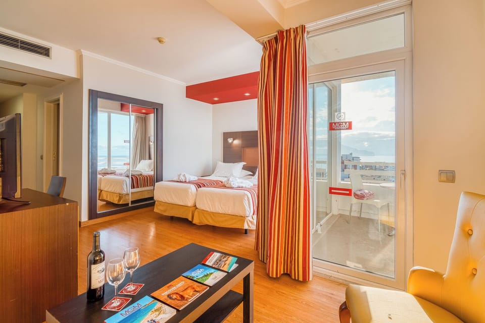 Sip wine by the balcony doors as ocean breezes roll in.