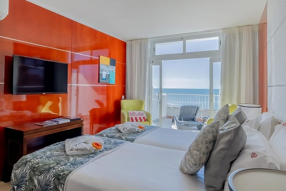 Wake up to sea breezes from your sunlit balcony bedroom.