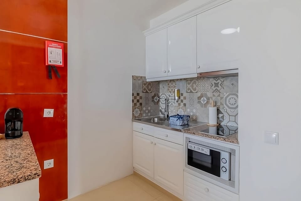 Cook light meals easily in this spotless, well-equipped kitchenette.