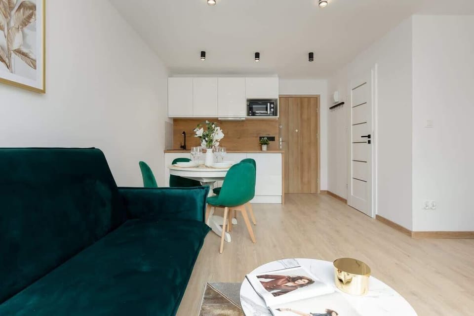 A full view of the open-plan interior, including the kitchen, dining area, and living space, blending functionality and style.
