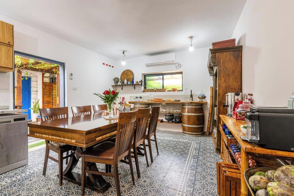 Spacious dining room with large wooden table, perfect for family meals