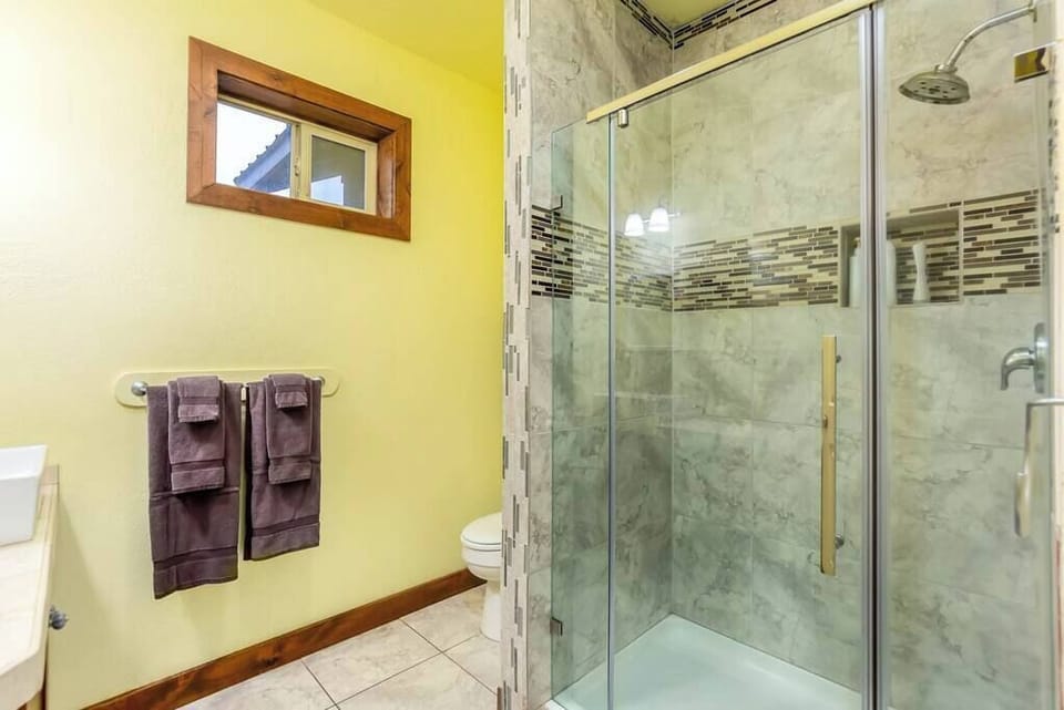 Large shared bathroom with standing shower.