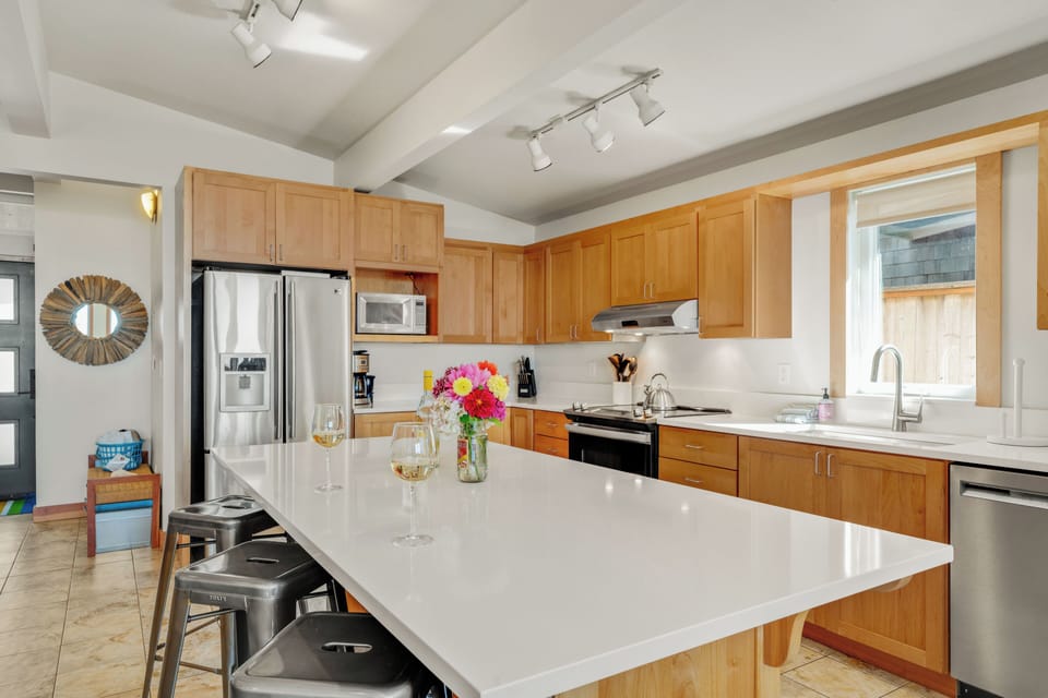 Large fully stocked kitchen with a large Island and three counter stools