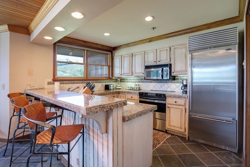 You'll love cooking in this gourmet kitchen with granite countertops, stainless steel appliances, and a breakfast bar for casual dining.