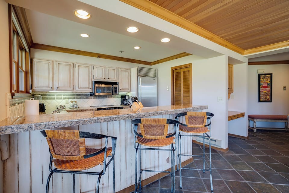 Your gourmet kitchen awaits with granite countertops, stainless appliances, and a breakfast bar where you'll enjoy morning coffee together.
