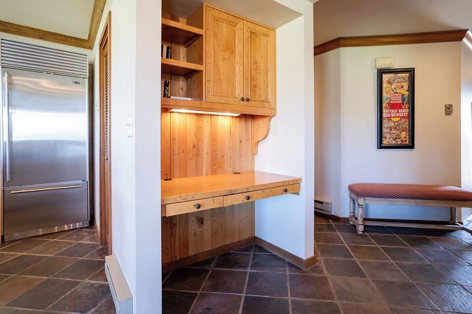 Your thoughtfully designed entryway features beautiful built-in wood cabinetry and a cozy bench, creating the perfect spot to settle in upon arrival.