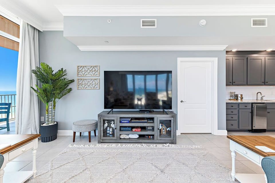 Relax in this welcoming family room with your favorite shows after a day at the beach
