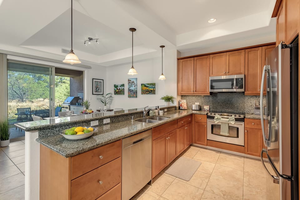 The chef-ready kitchen features granite counters and stainless appliances.