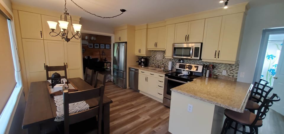 Dining table for 6-7 and breakfast counter for three.
