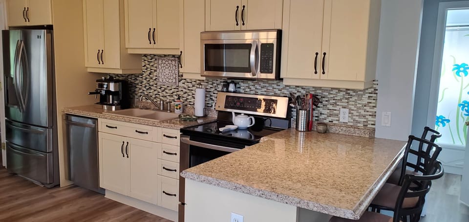 Kitchen with stainless steel appliances, d