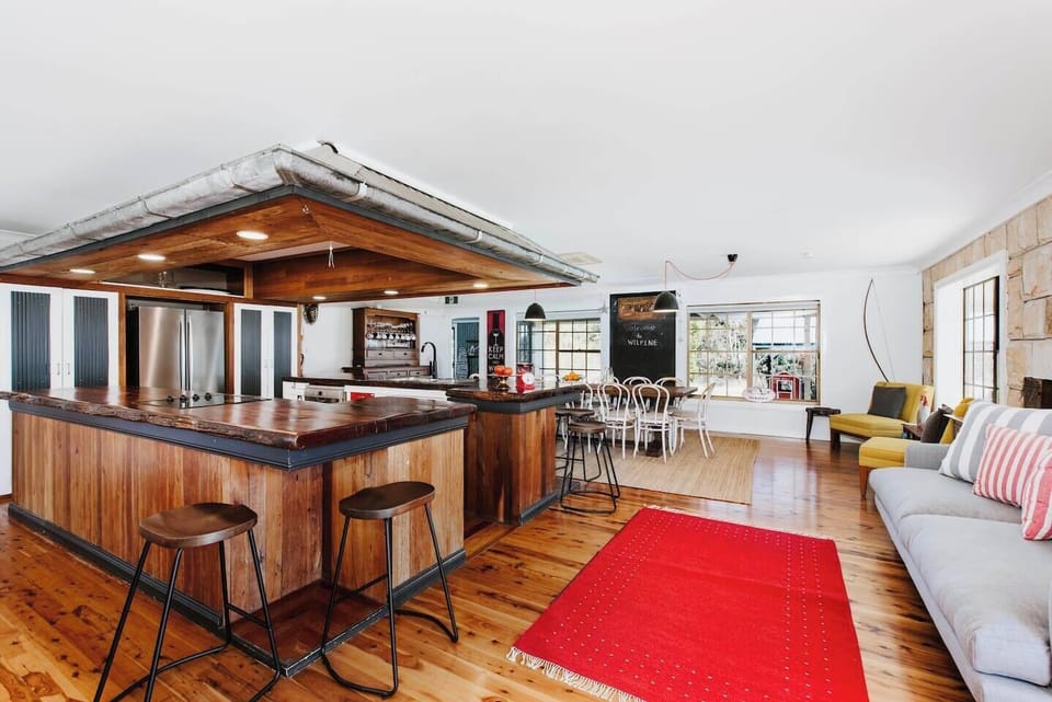 The striking timber kitchen provides a functional space to prepare meals at home.