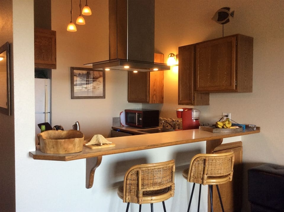 Kitchen has been opened up for ocean view while cooking