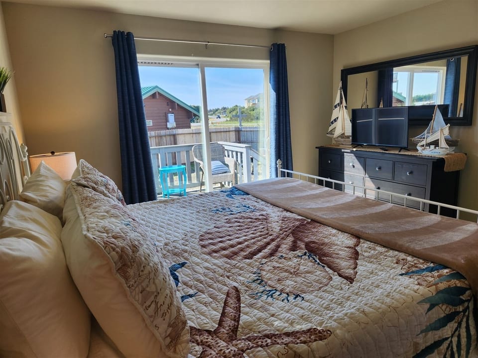 Another view of the king bedroom downstairs with a smart TV