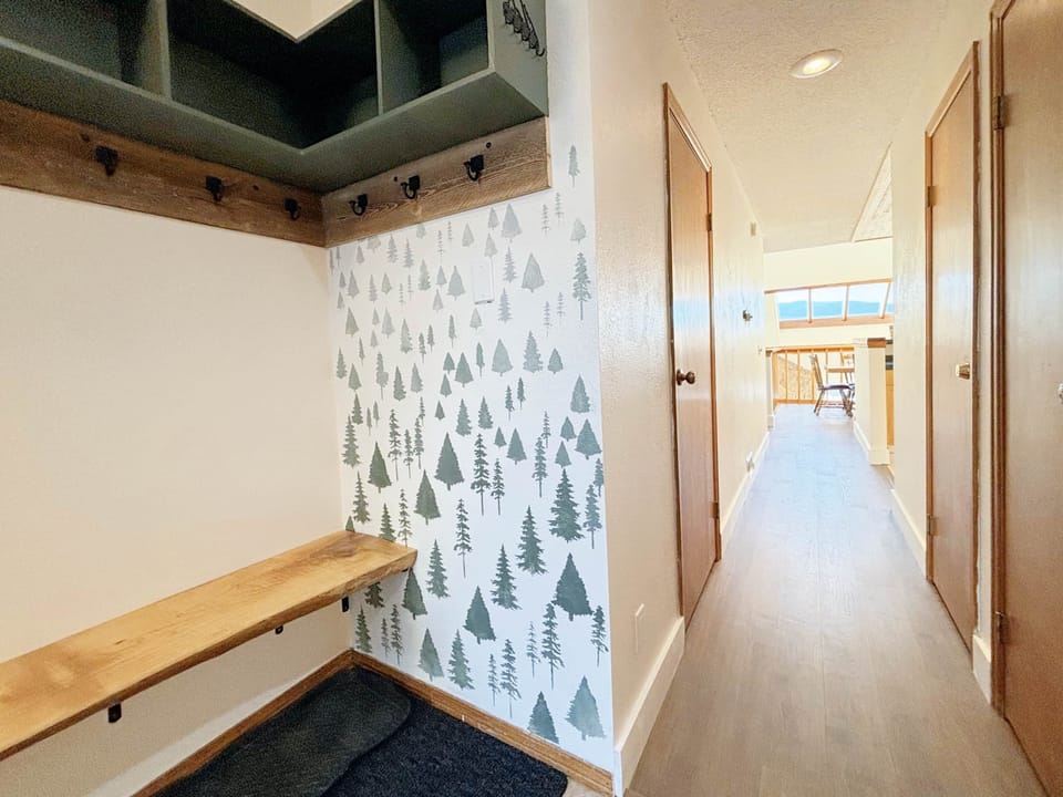 Entryway with plenty of hooks and space for storage.