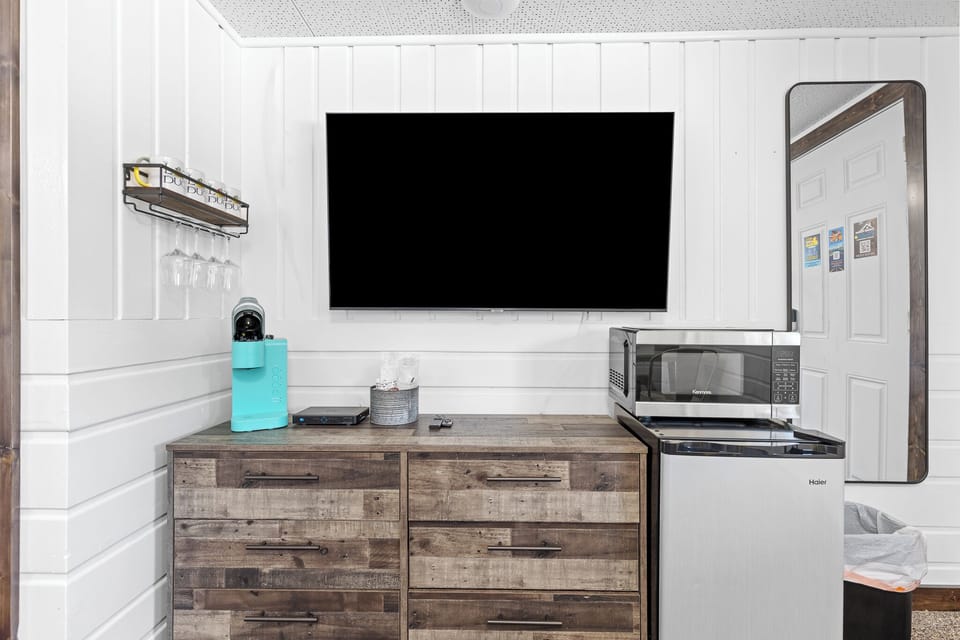 Flat screen Tv, large dresser, Keurig coffee machine, mini fridge and microwave