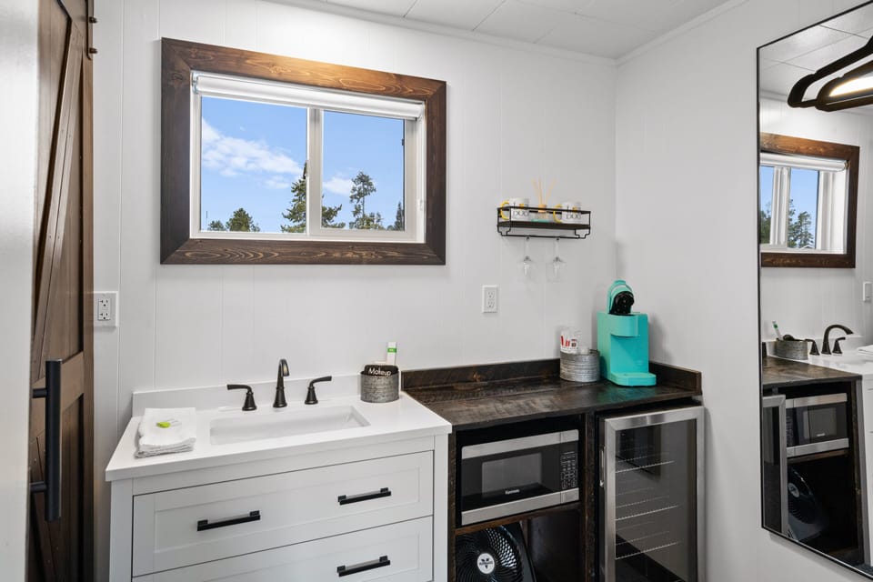 Sink next to microwave, mini fridge and Kreig coffee machine