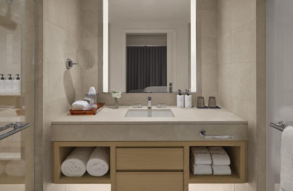 Refresh at the serene vanity with spa-like towels and lighting.