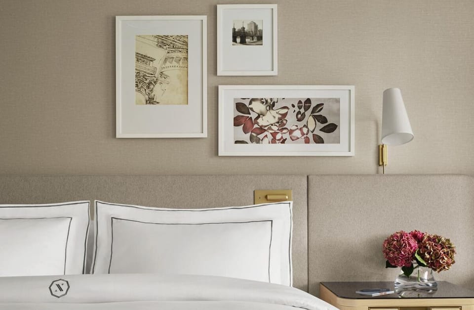 Relax into plush pillows beneath curated art and warm lighting.