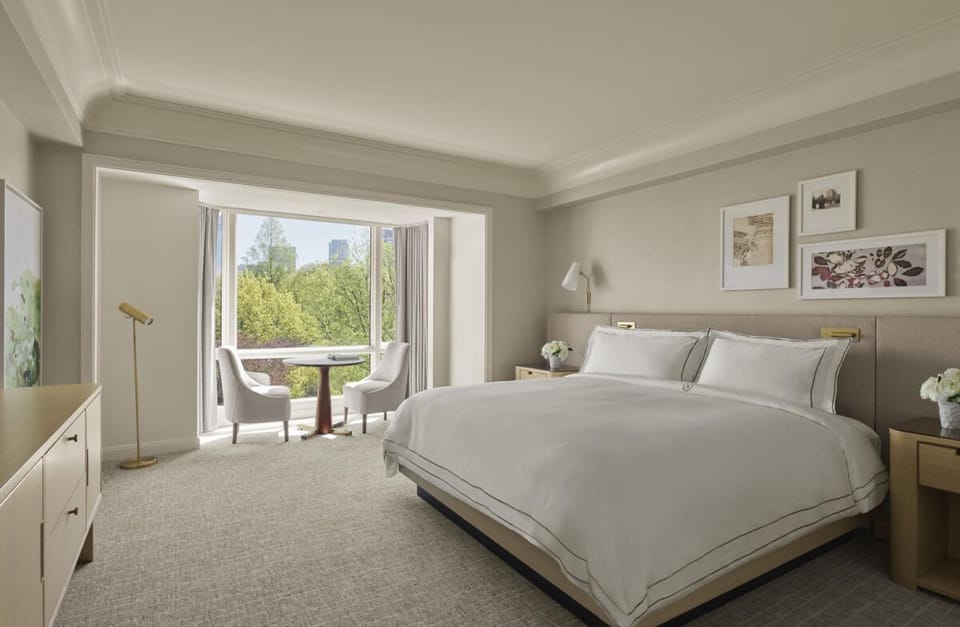 Wake up refreshed in soft bedding beside sun-filled windows.