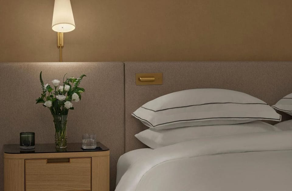Sink into plush pillows and enjoy soothing bedside lighting.