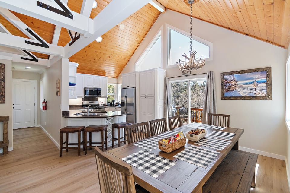 Share home-cooked meals and unhurried conversations in this spacious dining area, steps from the fully equipped kitchen and sunlit deck—made for memorable Big Bear gatherings.