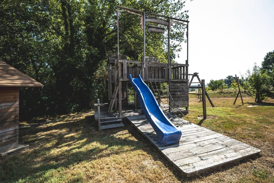 Outside: Large terraces - Tables - Charcoal BBQ - Above-ground swimming pool - Trampoline + Wooden play area for children.
