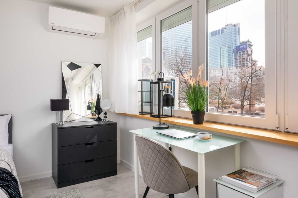 A dedicated workspace near the window, providing natural light and a productive, serene environment.

