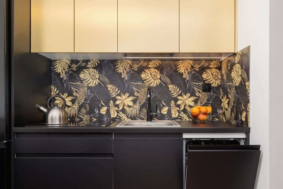 A close-up of the stylish kitchen showcasing the floral backsplash and minimalist design.
