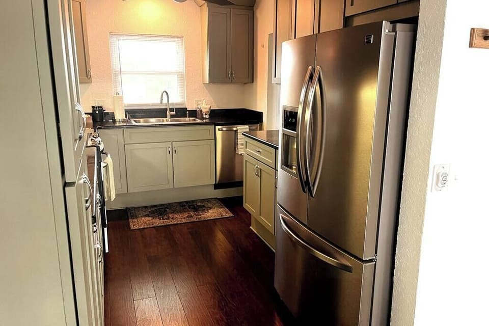 Beautifully appointed kitchen with stone countertops and stainless appliances